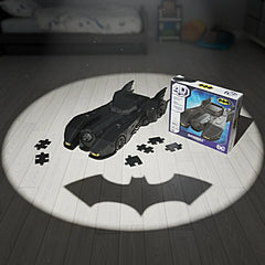 4D Build DC Batman Retro Batmobile 3D Puzzle Model Kit is a black, glossy toy car with bat-like design on a wooden floor.
