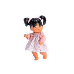Cheni doll with black pigtails, wearing a printed dress and pink jacket, designed by ASI for imaginative play.