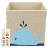Whale-shaped storage box in soft blue with playful details, featuring a beige linen look exterior and sturdy construction.