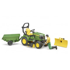 Bruder John Deere lawn tractor toy with trailer, figure kneeling, snow plough attachment beside.