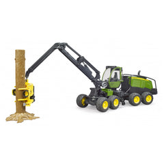 Bruder John Deere 1270G Harvester toy, green and yellow, with articulated arm grasping a tree trunk.