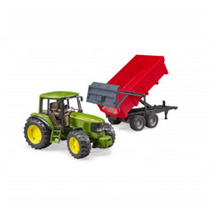 Green John Deere toy tractor with a red tipping trailer attached, on a white background.