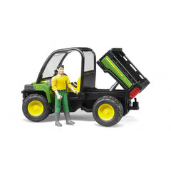 Bruder John Deere Gator XUV 855D toy with driver figure, green and yellow, tipper bed raised, on a white background.