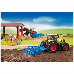 Toy tractor with Bruder Lemken Disc Cultivator in a farm scene with horses and barn in the background.