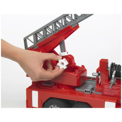 Hand adjusting white gear on Bruder fire engine ladder toy with red and gray details.