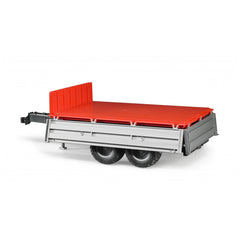 Red and grey Bruder platform gate trailer with dual wheels, 1:16 scale replica, angled view.