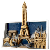 LEGO Eiffel Tower model in beige and brown, set against a blue cityscape with various architectural elements.
