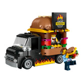 LEGO City Burger Truck set featuring a black truck with a giant burger on top, a vendor serving from a colorful food window, and a customer holding a burger.