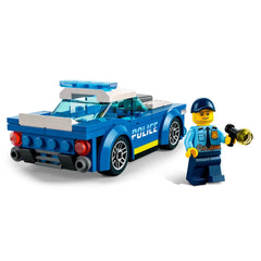 LEGO City Police Car in blue with a police officer minifigure holding a flashlight, ready for adventure. The car features sporty design elements like cool rims and a police badge.