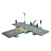 LEGO® City Road Plates construction set featuring a gray intersection with traffic lights, street signs, and landscaping elements.
