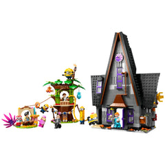 Construction set featuring Gru's family mansion in gray with purple accents, alongside a Minions treehouse play area. The set includes various Minion characters and accessories, with colorful elements including a pink plant and toys.