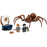 LEGO® Harry Potter™ Aragog set featuring a large, posable spider, a spider web, a small spider, and minifigures of Harry and Ron with wands and a lantern.