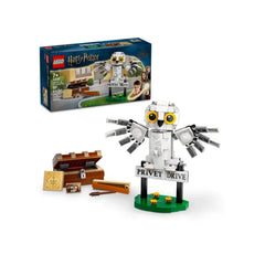 LEGO Harry Potter construction set featuring a posable Hedwig owl with yellow eyes, perched beside the "Privet Drive" sign, accompanied by a treasure chest and wands.
