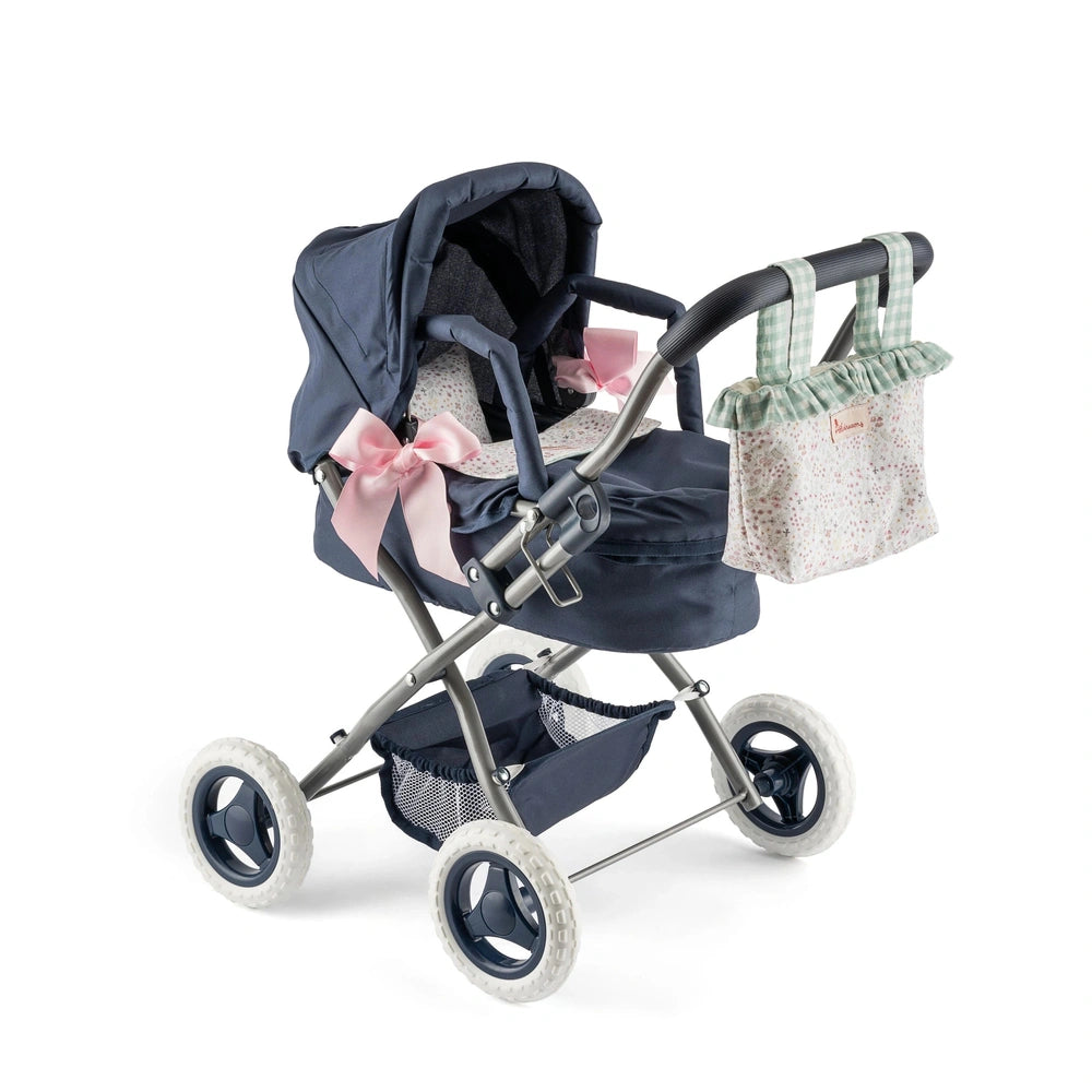 Navy blue toy stroller with pink bows, floral bedding, and a green checkered diaper bag attached to handle.