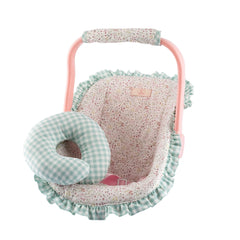 Pastel pink doll carrier with floral fabric, green checkered ruffle, and matching neck cushion.