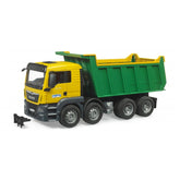 Yellow and green Bruder MAN TGS tipper truck toy with six wheels and open cab doors.