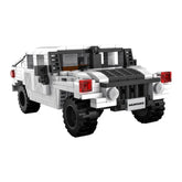 CaDA Humvee C-Series car construction set in white Lego bricks with black tires and red lights, viewed from the front.