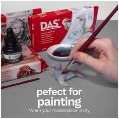 Das Modeling Clay - White 500 Gr. in a red box featuring white text and images, displayed on a gray surface with crafting too