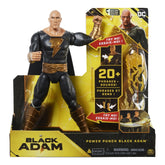Black Adam action figure in dynamic pose, featuring a black and gold costume, cape, and muscular build against yellow packagi