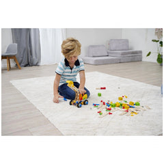 Eichhorn Constructor 3in1 construction set with colorful pieces is being played with by a young boy on a light rug.