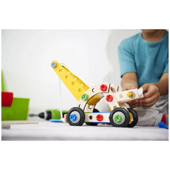 Eichhorn Constructor 4in1 construction set with yellow frame and colorful pieces being assembled by a child at a table.