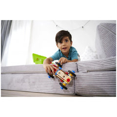 Eichhorn Constructor Racer Car is held by a young boy in a blue shirt, sitting on a grey sofa with a white background.