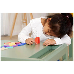 Eichhorn Wooden Domino Ralley, a child plays with colorful blocks in a cozy indoor space, showcasing creativity and focus.
