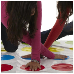 HASBRO Twister board game in Italian edition with two players on a shiny floor featuring red, blue, and yellow circles.