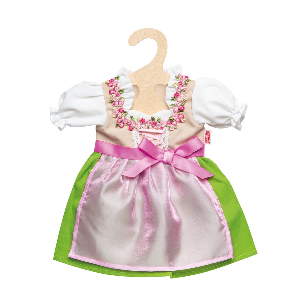 Heless Dirndl Heidi dress in pink with a white bodice and green trim, hanging on a light wooden hanger.