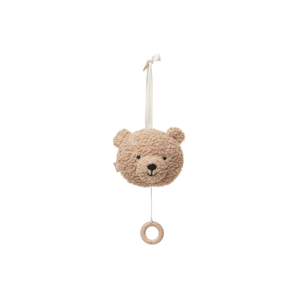 Brown teddy bear hanging from a white string and hook, designed as a musical hanger for stuffed animals.