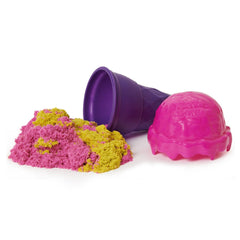 Kinetic Sand Ice Cream Cone Container in pink with yellow sand and a purple scooping container on a white background.