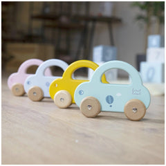 Blue, yellow, pink, and white wooden push and pull toy cars with four wheels arranged centrally.
