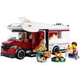 LEGO City Holiday Adventure camper van with two characters, one playing guitar and the other holding a baby, near a campfire.