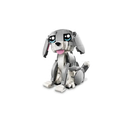 A cute, gray and white LEGO® Creator 3in1 Playful Cat construction set with large expressive eyes and a pink tongue, sitting with a playful stance.
