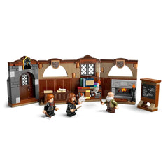LEGO Harry Potter Hogwarts Charms Class set featuring three figures engaged in spell-casting, with desks, a chalkboard, and a fireplace.