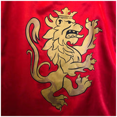 Liontouch red knight cape featuring a golden lion with a crown, raised paws, and open mouth on smooth glossy fabric.