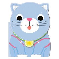MACRO JUNIOR book featuring a matte-furred cat with pink features and a colorful star collar on a flat surface.