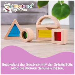 Montessori Window Building Blocks Set featuring colorful wooden shapes on a light surface, accompanied by a plant.