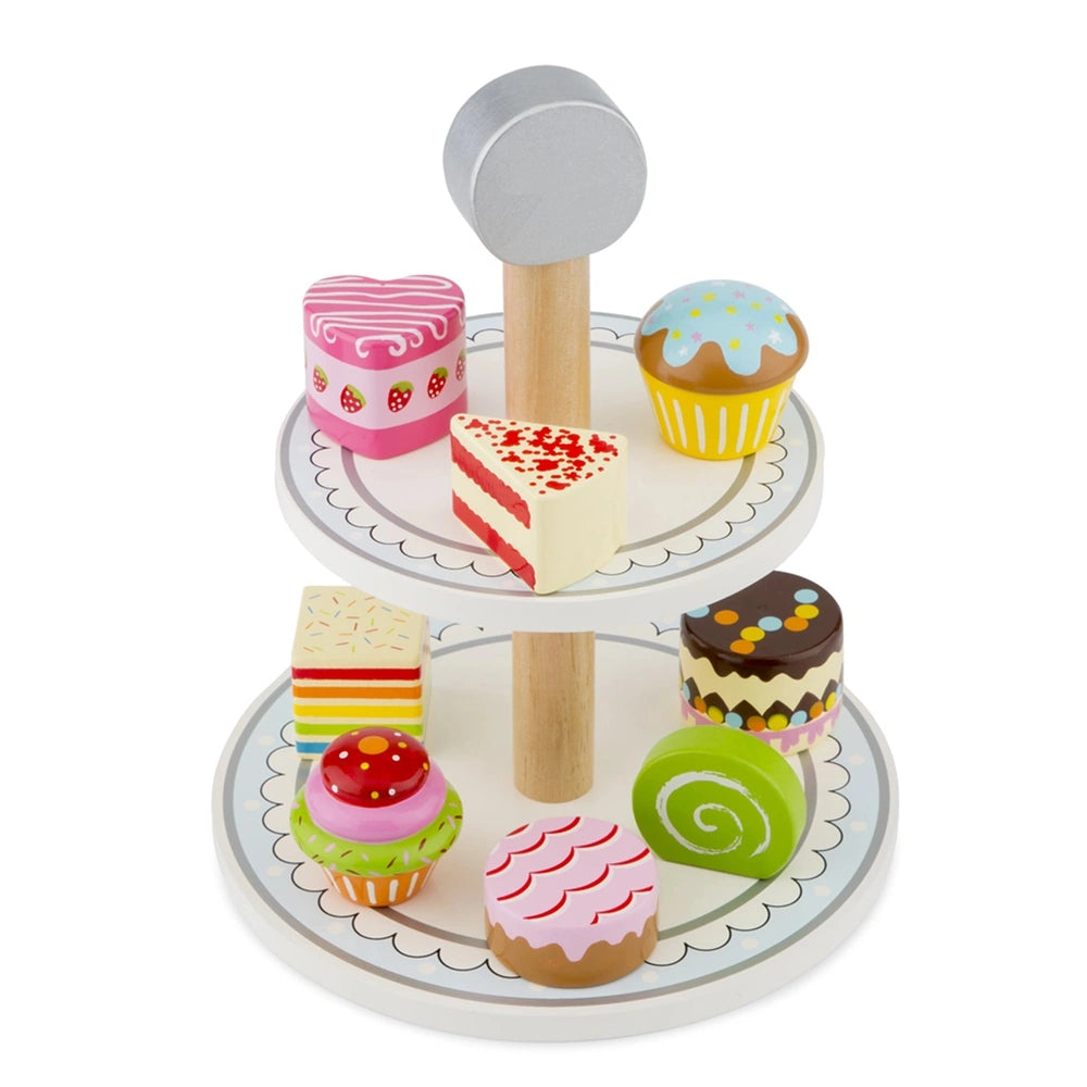 New Classic Toys Cake Stand Set features colorful cupcakes with various icing designs on a white round flat surface.