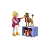 Playmobil Dog-Groomer toy set featuring a plastic doll and dog, with blue collar and brown leash.