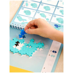 Plus Plus Ocean Activity Pad in blue on a flat, light-colored surface, designed for engaging puzzles and activities.