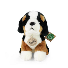 Plush mountain dog toy with black and white markings, floppy ears, and eco-friendly tag against a plain white background.