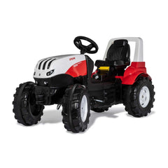 Rollyfarmtrac Premium II Steyr 6300 Terrus CVT is a red and white all-terrain vehicle with rubber wheels and a cushioned seat