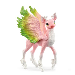 Magical fawn toy figure with pink body, green wings, and feathered tail, standing upright on a white surface.