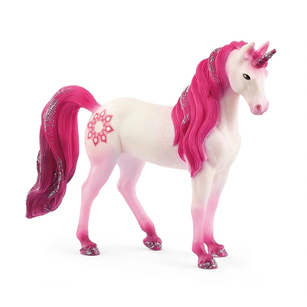 A white unicorn figurine with a vibrant pink mane and tail, featuring a decorative pattern, stands facing the viewer.