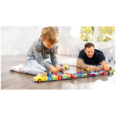 Siku Adam Addy Toddys construction set toys are being played with by a focused child on a light-colored carpet in a cozy room