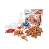 Teifoc fire station construction set with brown bricks, wooden planks, and a blue bowl on a white surface.