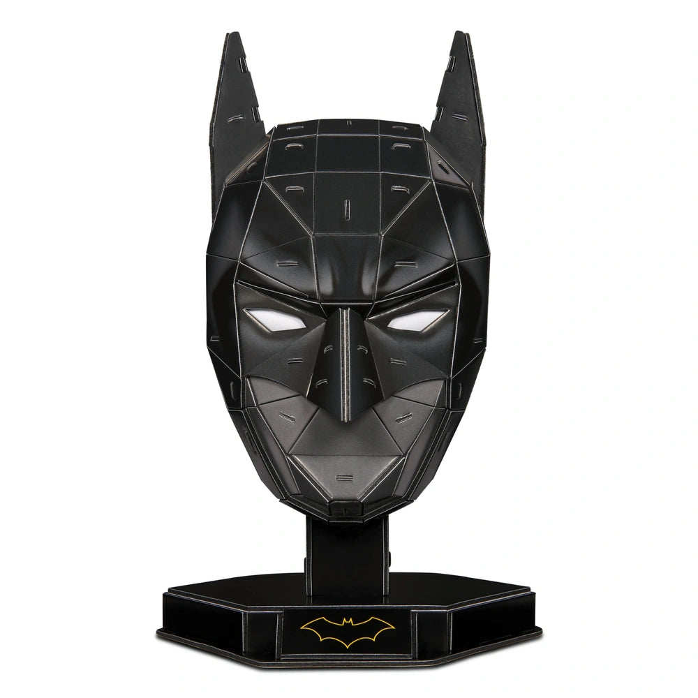 4D Build DC Batman mask puzzle model kit in glossy black, featuring pointed ears and geometric design against a light backgro