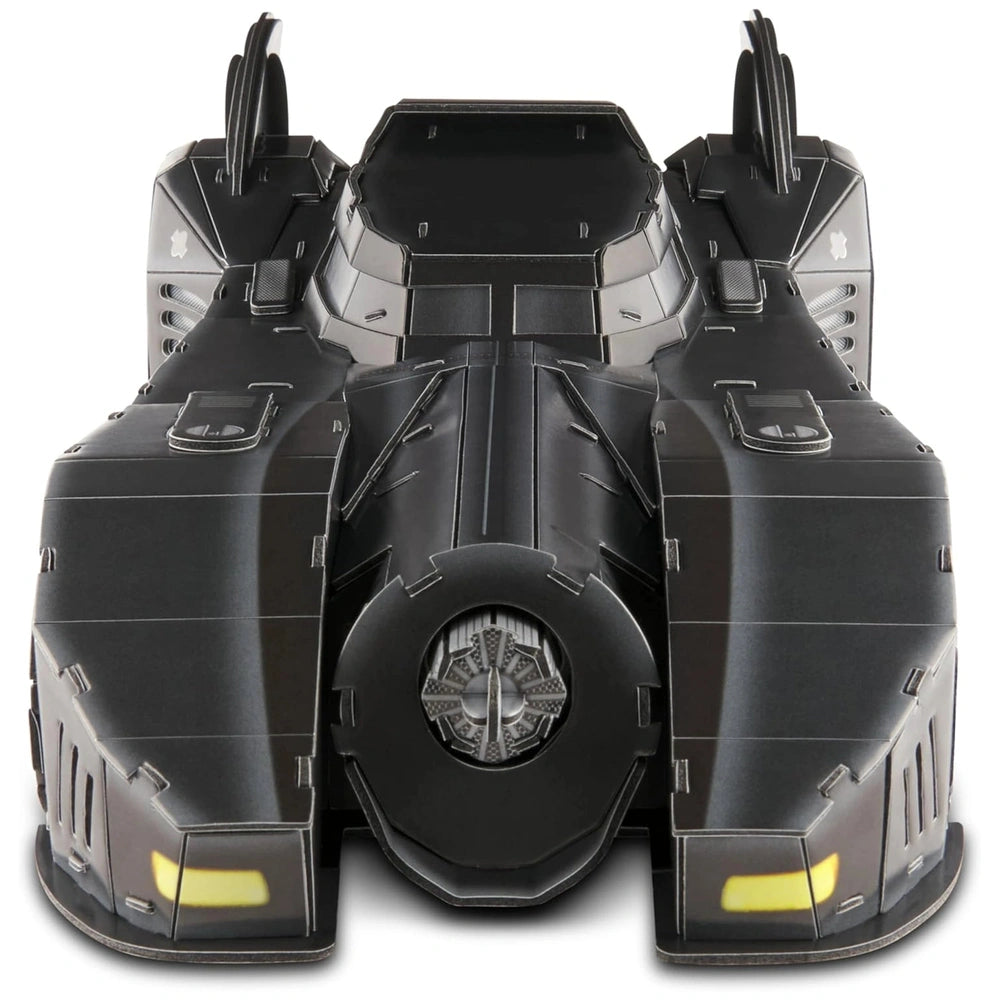 Black futuristic Batmobile model with glossy finish and yellow highlights, set against a contrasting white background.
