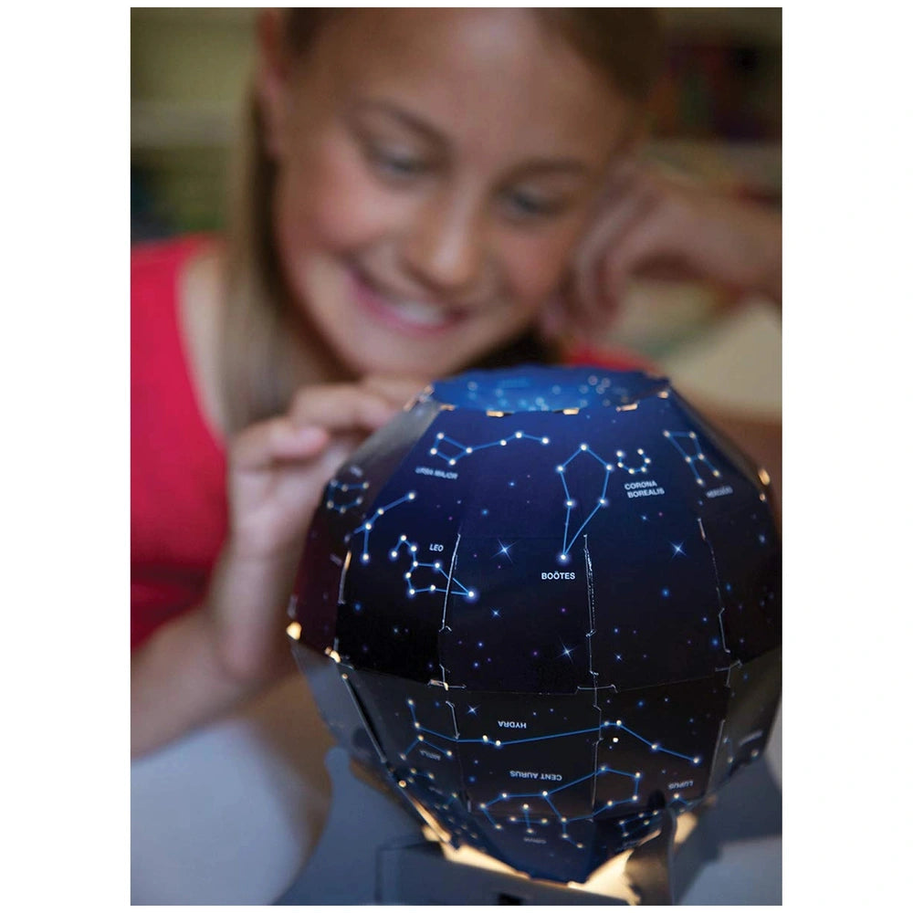4M KidzLabs Night Sky Projection Kit in dark blue with stars, spherical shape, glossy surface, with a smiling girl in the bac